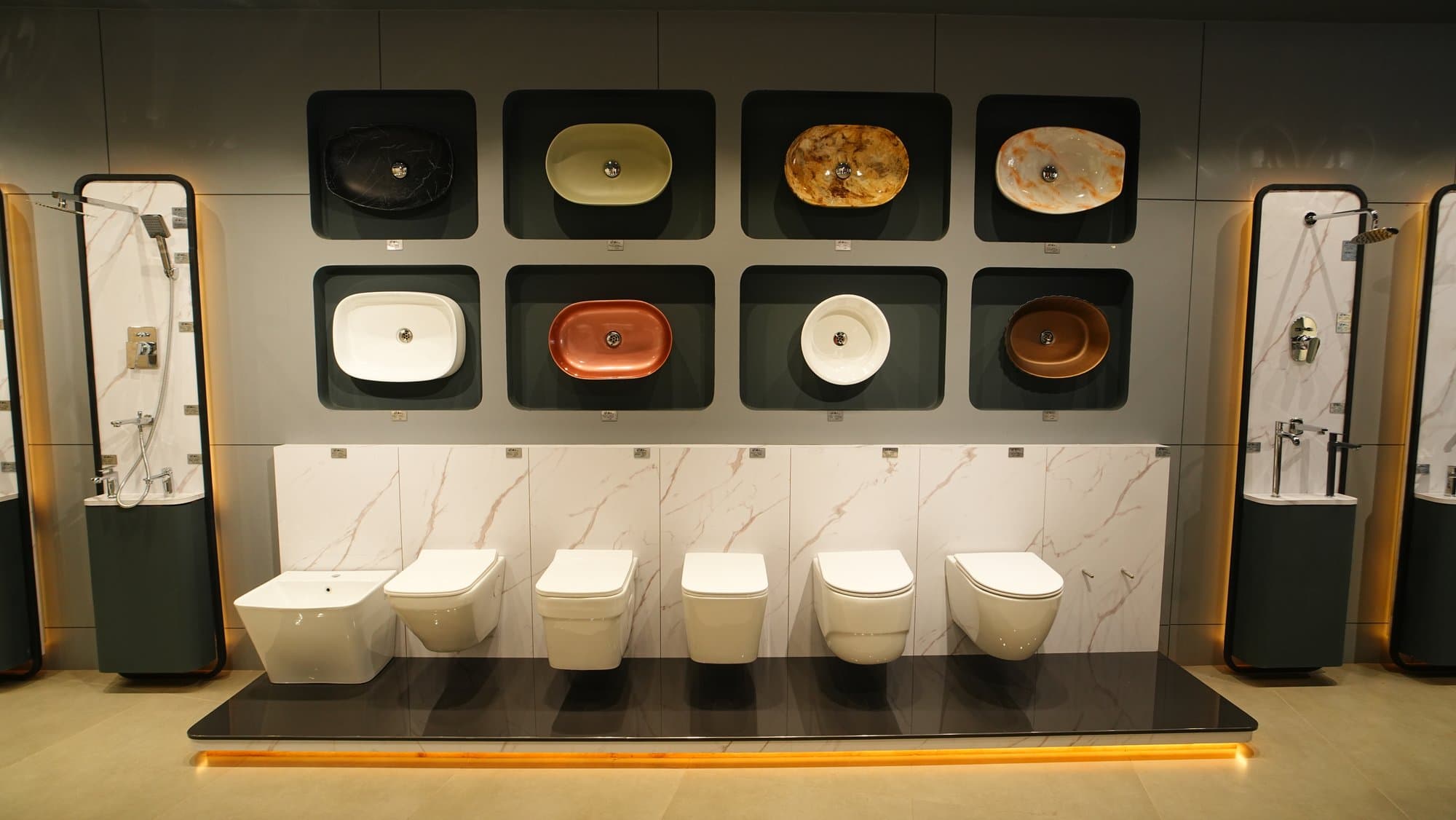 A wall of designer wash basins and wall-hung WCs on display at Star Tiles
